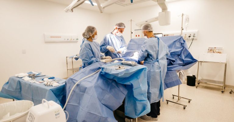 medical professionals conduct surgery in a sterile well equipped operating room